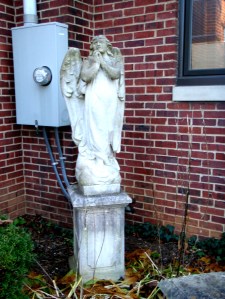 This beautiful work is an actual sculpture, not a lawn ornament. It is on the grounds of a church, but it is in an awkward spot, next to the electric box. Perhaps the sorrowful angel would be a bit happier if she was in a better space. Thanks to my cousin for pointing this out. November 2010.
